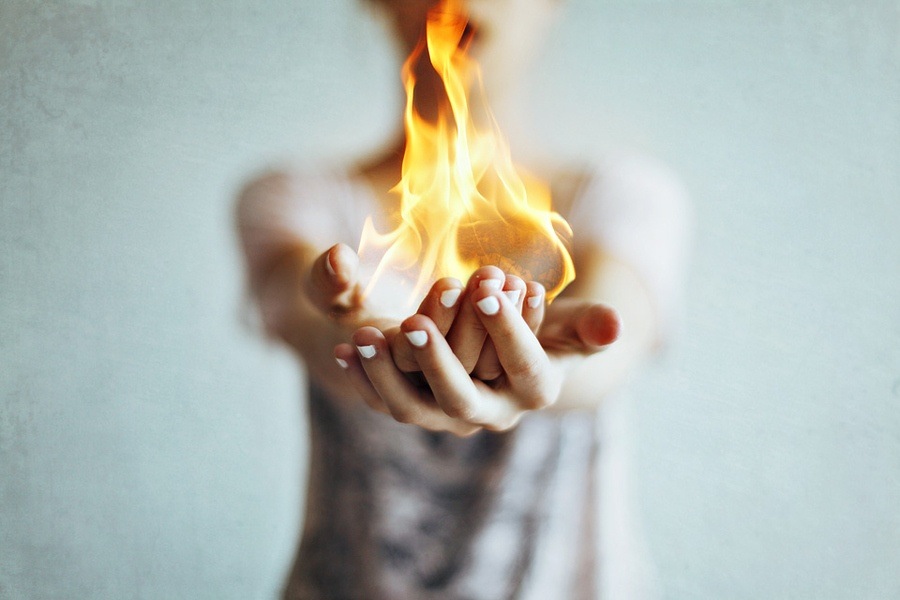 Photographer-unknown_Woman-holding-flame-in-cupped-hands